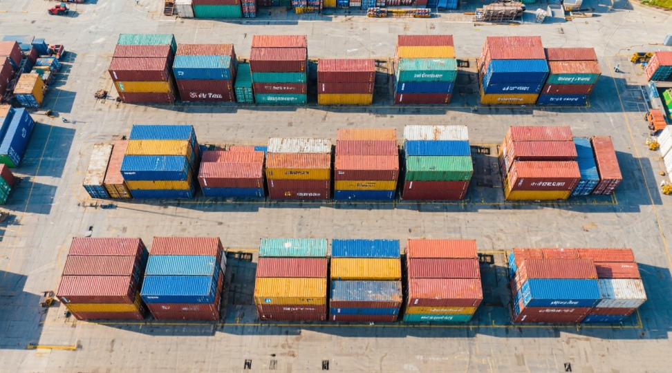 Aerial view of shipping containers neatly stacked at a logistics hub. This reflects the scale and efficiency of DR Trans’s sea freight operations from China to Europe.